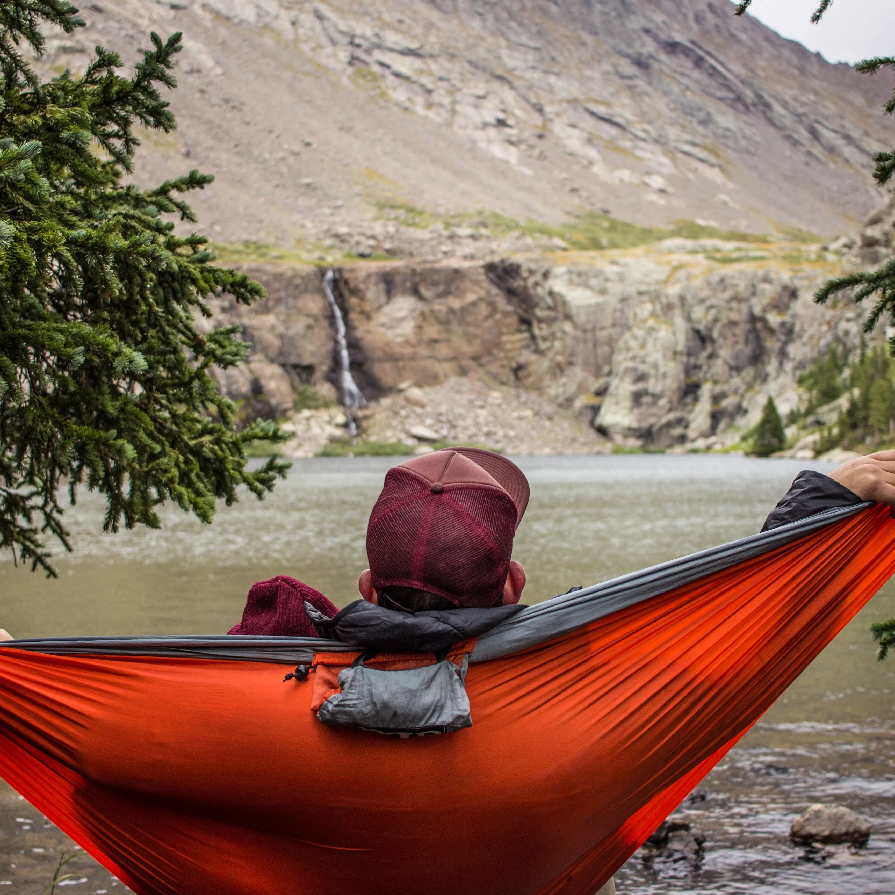 man relaxing in hammock